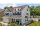Two-story home with grey siding, a two-car garage, and a cozy front porch with outdoor seating at 528 Brycewood Dr, Burlington, NC 27215