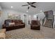 Cozy living room featuring a comfortable leather sofa and armchair near the stairway at 528 Brycewood Dr, Burlington, NC 27215