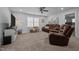 This living room features a leather sofa and recliner, ceiling fan, neutral walls, and plush carpet at 528 Brycewood Dr, Burlington, NC 27215