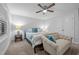 The main bedroom features plush carpet, a ceiling fan, a side table with a lamp, and a bench at 528 Brycewood Dr, Burlington, NC 27215