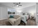The main bedroom features a ceiling fan, bench, plush carpet, and shutters for an abundance of natural light at 528 Brycewood Dr, Burlington, NC 27215