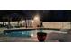 Sparkling in-ground pool at night, complemented by a charming shed and cozy seating area at 528 Brycewood Dr, Burlington, NC 27215