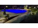 Backyard pool with in-ground lighting, surrounded by manicured landscaping and a privacy fence at 528 Brycewood Dr, Burlington, NC 27215