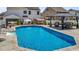 Beautiful in-ground pool with an adjacent gazebo lounge area surrounded by manicured landscaping at 528 Brycewood Dr, Burlington, NC 27215