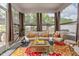 Relaxing sunroom features stylish furniture, colorful decor, and beautiful views of the backyard at 528 Brycewood Dr, Burlington, NC 27215