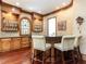 Charming bar area with custom cabinets, a stained glass window and bar seating at 5420 Deer Forest Trl, Raleigh, NC 27614