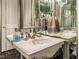 Elegant bathroom featuring a unique vessel sink, detailed hardware, and mirrored walls at 5420 Deer Forest Trl, Raleigh, NC 27614