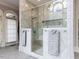 Spacious marble shower with glass enclosure and bench seating, complemented by stylish fixtures at 5420 Deer Forest Trl, Raleigh, NC 27614