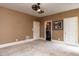 Neutral carpeted bedroom with three doors, neutral walls, and modern ceiling fan at 5420 Deer Forest Trl, Raleigh, NC 27614