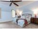 Cozy bedroom with slanted ceiling, floral bedding, and a statement ceiling fan at 5420 Deer Forest Trl, Raleigh, NC 27614