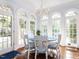Sun-filled breakfast nook features a charming chandelier and bright light from large windows at 5420 Deer Forest Trl, Raleigh, NC 27614