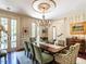 Elegant dining room features hardwood floors, decorative chandelier, and floor to ceiling windows at 5420 Deer Forest Trl, Raleigh, NC 27614