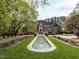 Stately brick home with manicured lawn, fountain, and lush landscaping at 5420 Deer Forest Trl, Raleigh, NC 27614