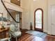 Inviting foyer with hardwood floors, staircase, and elegant arched front door at 5420 Deer Forest Trl, Raleigh, NC 27614