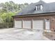 Spacious three-car garage of brick home with ample parking space and convenient access at 5420 Deer Forest Trl, Raleigh, NC 27614