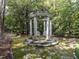 Elegant stone gazebo with stately columns, providing a serene outdoor retreat at 5420 Deer Forest Trl, Raleigh, NC 27614