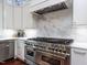 Modern kitchen with stainless steel appliances, custom cabinets, and marble backsplash at 5420 Deer Forest Trl, Raleigh, NC 27614