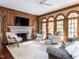 Spacious living room featuring a fireplace, wood paneling, and lots of natural light at 5420 Deer Forest Trl, Raleigh, NC 27614
