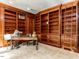 Office with wooden bookshelves surrounding the wall and a dark wooden desk in the center at 5420 Deer Forest Trl, Raleigh, NC 27614