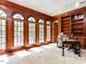 Sophisticated office with rich wood paneling, arched windows, and built-in bookshelves at 5420 Deer Forest Trl, Raleigh, NC 27614