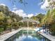 Aerial view of a luxurious pool and surrounding backyard of an estate property at 5420 Deer Forest Trl, Raleigh, NC 27614