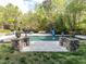 A backyard pool with stone accents and lush landscaping has plenty of room for fun at 5420 Deer Forest Trl, Raleigh, NC 27614
