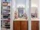 Well-lit bathroom with double sinks, wood cabinets, and a closet at 6001 Winterpointe Ln # 102, Raleigh, NC 27606