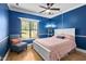 Stylish bedroom with hardwood floor, a ceiling fan, and a seating area at 6001 Winterpointe Ln # 102, Raleigh, NC 27606