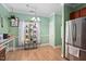 Bright dining area with plants and stainless steel fridge at 6001 Winterpointe Ln # 102, Raleigh, NC 27606