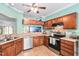 Charming kitchen with wood cabinets, stainless steel appliances, and a view to another room at 6001 Winterpointe Ln # 102, Raleigh, NC 27606