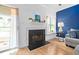 Fireplace with black trim, white mantel and decor, and light-filled windows at 6001 Winterpointe Ln # 102, Raleigh, NC 27606