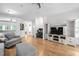 Spacious living room with hardwood floors, entertainment center, and adjoining office space at 6001 Winterpointe Ln # 102, Raleigh, NC 27606