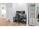 Dedicated office space with dual monitors, ergonomic chair, and a stylish display cabinet at 6001 Winterpointe Ln # 102, Raleigh, NC 27606
