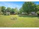 Large backyard perfect for outdoor entertaining featuring a fire pit, shed, and plenty of green space at 604 Sinewell Dr, Wake Forest, NC 27587