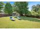 This backyard offers a well-manicured lawn with lawn chairs, offering space for outdoor relaxation at 604 Sinewell Dr, Wake Forest, NC 27587