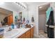 Bathroom with large mirror, dual sink vanity, and a shower at 604 Sinewell Dr, Wake Forest, NC 27587