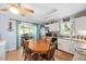 Bright dining area with a large wooden table and access to the backyard at 604 Sinewell Dr, Wake Forest, NC 27587