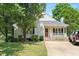 Inviting home with a brick-lined porch, mature trees, and a well-manicured lawn at 604 Sinewell Dr, Wake Forest, NC 27587