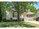 Beautiful home with a brick-lined porch and lush green lawn at 604 Sinewell Dr, Wake Forest, NC 27587