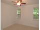 Bedroom features neutral carpet, base trim, ceiling fan, and two large windows for lots of light at 6673 Nc 96 W Hwy, Youngsville, NC 27596