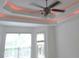 This bedroom features neutral carpet, base trim, ceiling fan, and a coffered ceiling with accent lighting at 6673 Nc 96 W Hwy, Youngsville, NC 27596