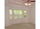 This bedroom features neutral carpet, base trim, ceiling fan, and three large windows for lots of light at 6673 Nc 96 W Hwy, Youngsville, NC 27596