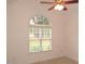 Bedroom features neutral carpet, base trim, ceiling fan, and a arched window for lots of light at 6673 Nc 96 W Hwy, Youngsville, NC 27596