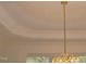 Detailed view of the dining room chandelier and ceiling trim at 6673 Nc 96 W Hwy, Youngsville, NC 27596