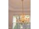 Close-up of the dining room's elegant, ornate chandelier at 6673 Nc 96 W Hwy, Youngsville, NC 27596