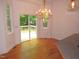 Dining area illuminated by a chandelier, offering access to the back deck at 6673 Nc 96 W Hwy, Youngsville, NC 27596