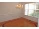 Dining room with hardwood floors, wainscoting and view of hanging chandelier at 6673 Nc 96 W Hwy, Youngsville, NC 27596
