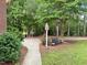 The side of the house with driveway and decorative bench at 6673 Nc 96 W Hwy, Youngsville, NC 27596