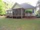 Back view of home featuring a backyard, screened in porch, and wooden deck at 6673 Nc 96 W Hwy, Youngsville, NC 27596