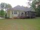Back view of home featuring a backyard, screened in porch, and wooden deck at 6673 Nc 96 W Hwy, Youngsville, NC 27596